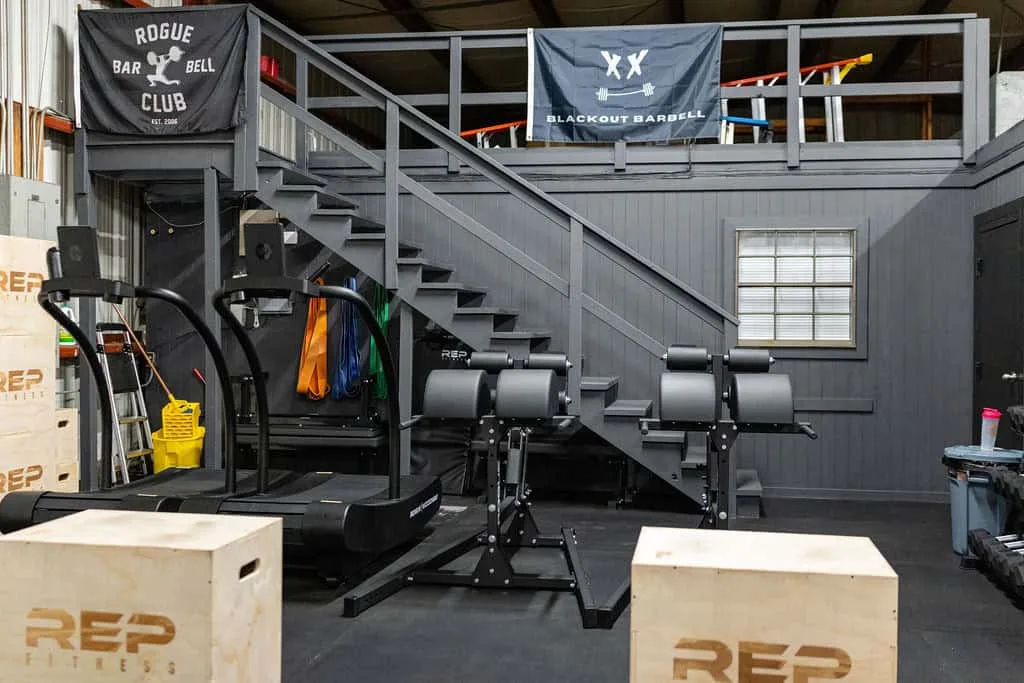 Treadmills, benches and plyo boxes beneath the mezzanine