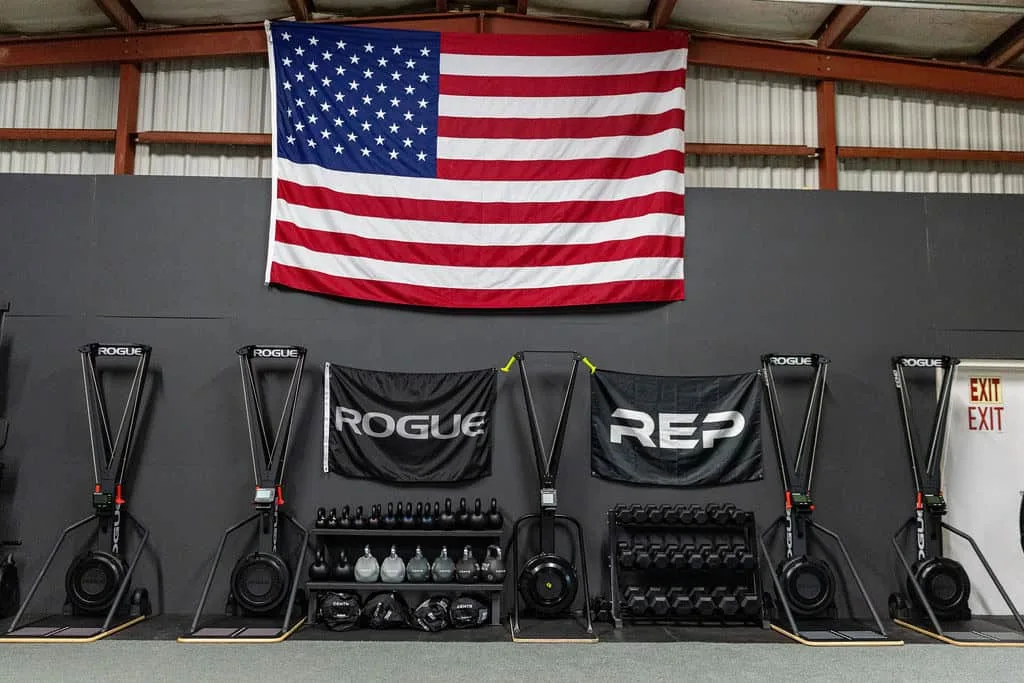 Rowing machines lined up under the American flag